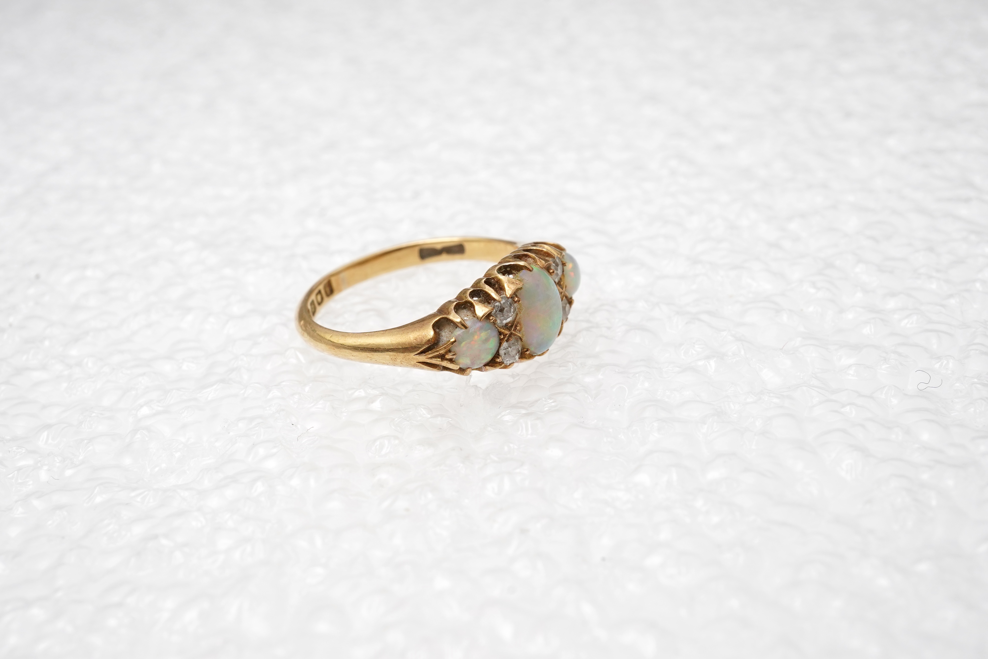 An Edwardian opal and diamond ring, circa 1904